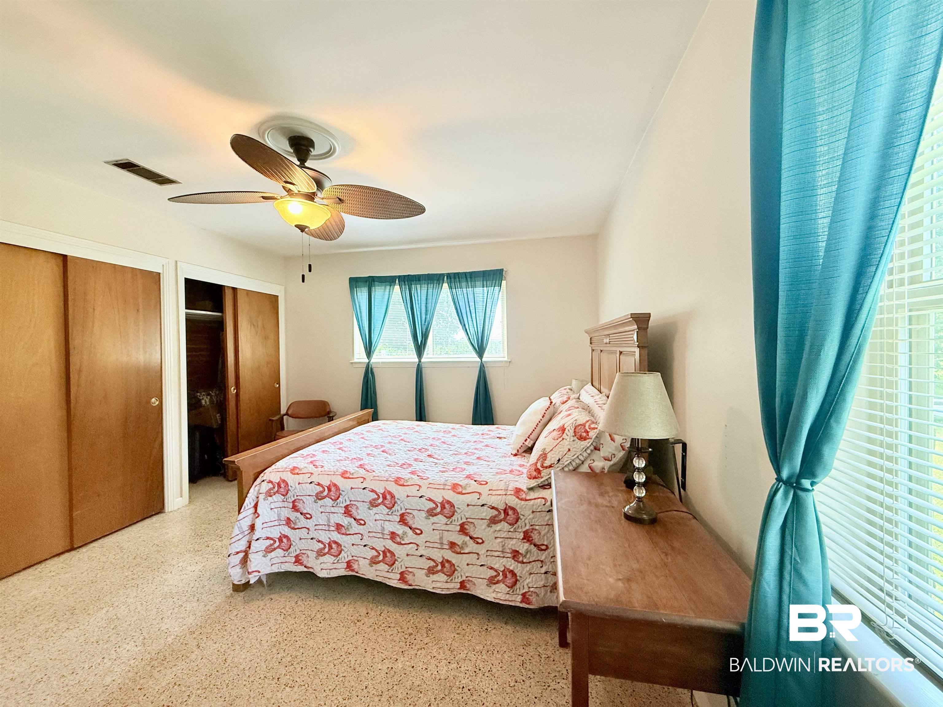 15931 Flowerwood Road Loxley, AL 36551 - Photo 8 of 27 Bedroom with two closets, ceiling fan, and speckle patterned floor