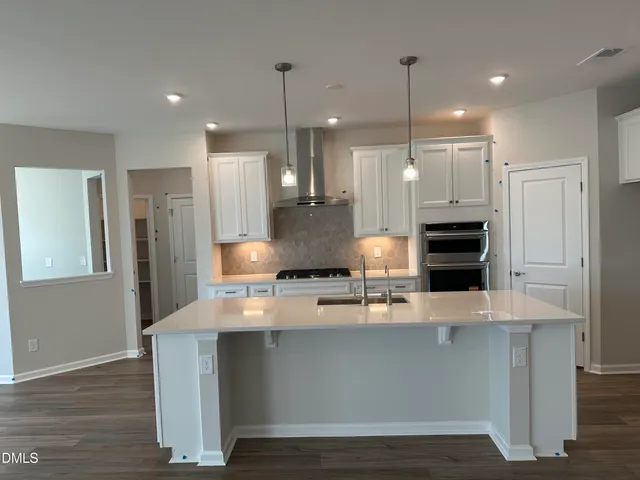 a large kitchen with stainless steel appliances kitchen island a large island in the center