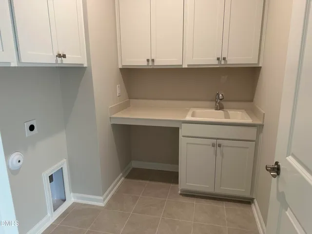 a bathroom with a sink and cabinets