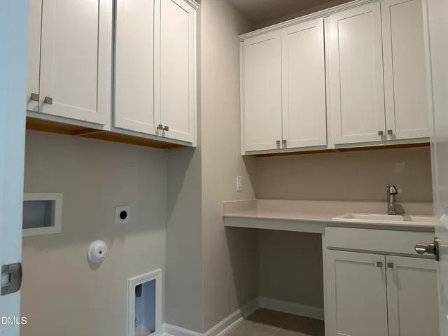 a kitchen with white cabinets and a sink