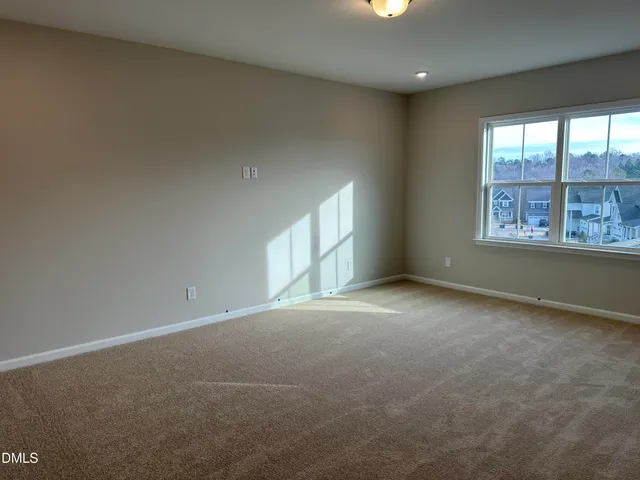 an empty room with a empty space and windows
