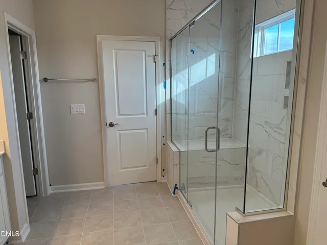 a bathroom with a glass shower door