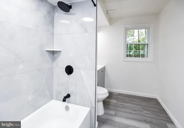 a bathroom with a sink a toilet and a tub