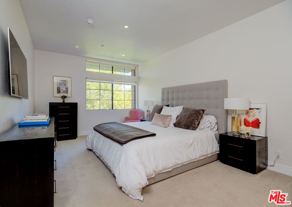 200 North Swall Drive, Unit PH6 Beverly Hills, CA 90211 - Photo 11 of 22 a bedroom with a bed and a dresser next to a window