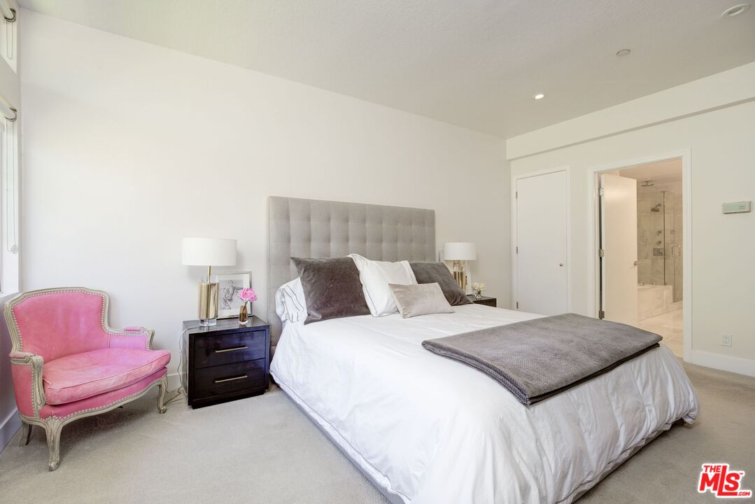 200 North Swall Drive, Unit PH6 Beverly Hills, CA 90211 - Photo 12 of 22 a bedroom with a bed and a couch