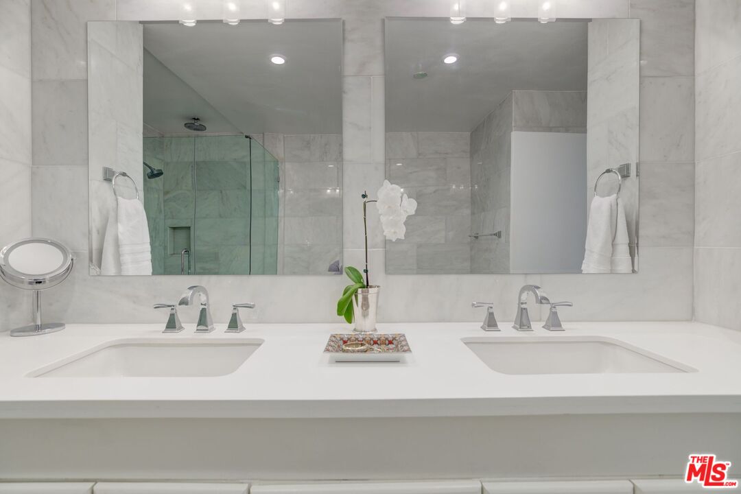 200 North Swall Drive, Unit PH6 Beverly Hills, CA 90211 - Photo 13 of 22 a bathroom with double vanity sinks and a mirror
