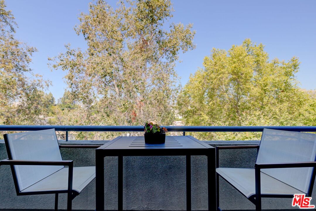 200 North Swall Drive, Unit PH6 Beverly Hills, CA 90211 - Photo 14 of 22 a view of a chairs and table on the deck