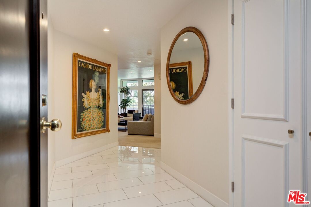 200 North Swall Drive, Unit PH6 Beverly Hills, CA 90211 - Photo 3 of 22 a view of a hallway with entryway wooden floor and a living room