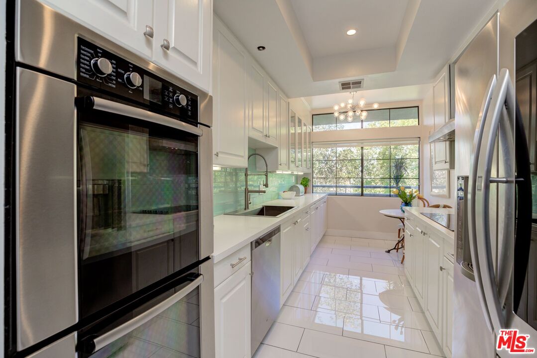 200 North Swall Drive, Unit PH6 Beverly Hills, CA 90211 - Photo 6 of 22 a kitchen with a refrigerator and a sink