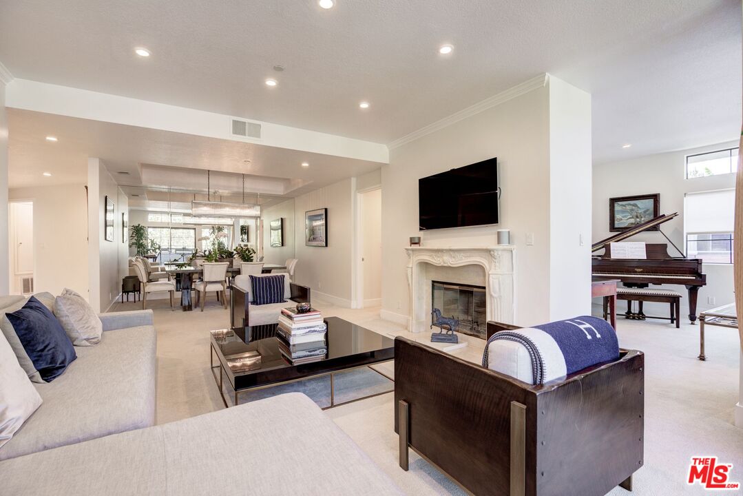 200 North Swall Drive, Unit PH6 Beverly Hills, CA 90211 - Photo 8 of 22 a living room with furniture a fireplace and a flat screen tv