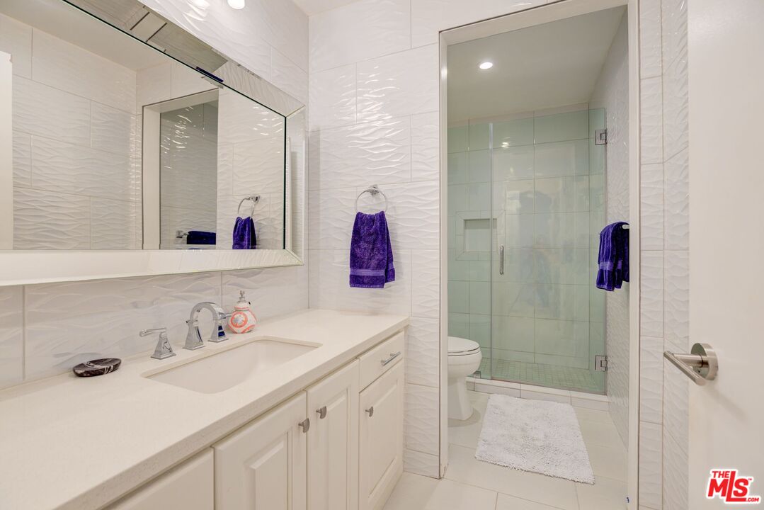 200 North Swall Drive, Unit PH6 Beverly Hills, CA 90211 - Photo 10 of 22 a bathroom with a sink vanity mirror and shower