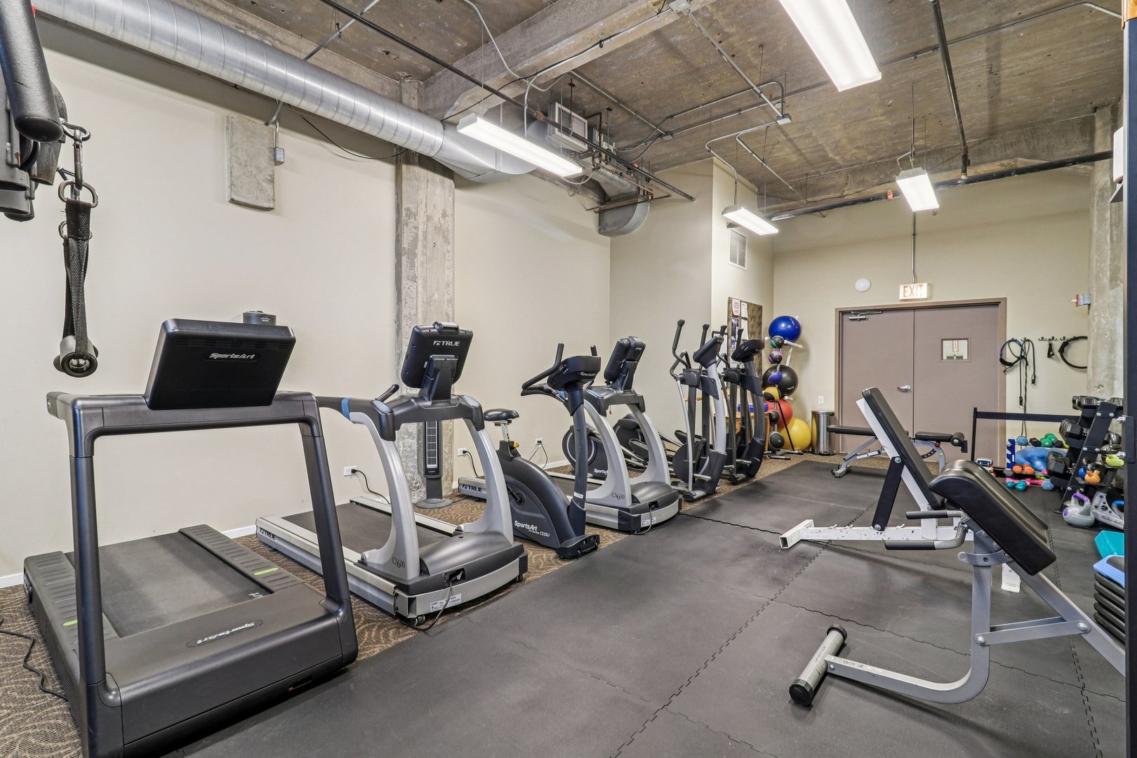 210 South Desplaines Street, Unit 304 Chicago, IL 60661 - Photo 13 of 19 a view of a room with gym equipment