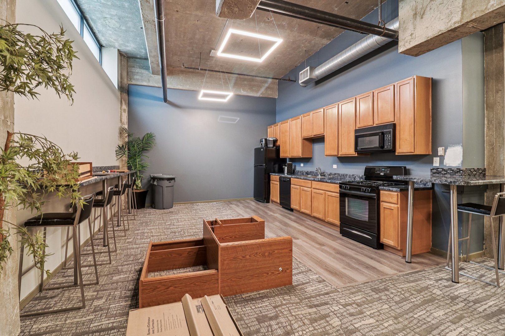 210 South Desplaines Street, Unit 304 Chicago, IL 60661 - Photo 14 of 19 a kitchen with stainless steel appliances kitchen island granite countertop a stove a sink and a microwave