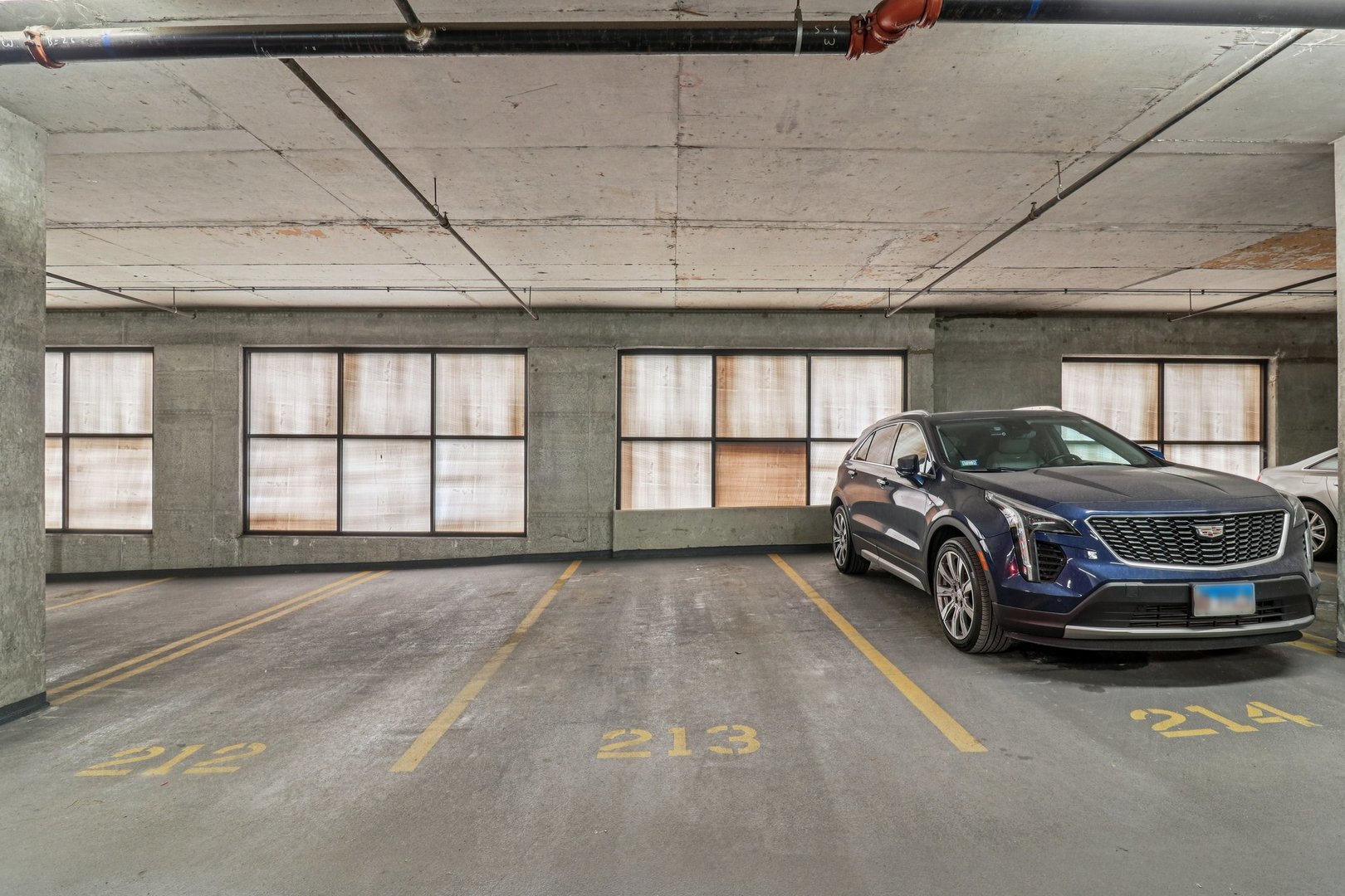 210 South Desplaines Street, Unit 304 Chicago, IL 60661 - Photo 17 of 19 a car parked in a room next to a window