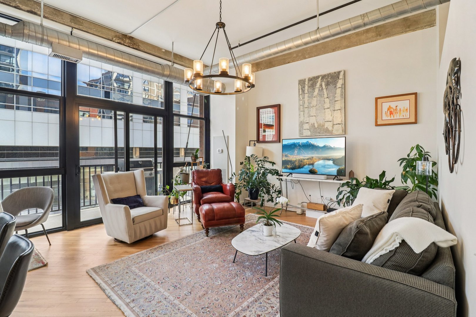 210 South Desplaines Street, Unit 304 Chicago, IL 60661 - Photo 2 of 19 a living room with furniture and a chandelier