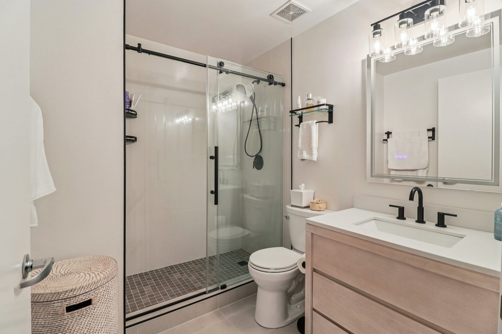 210 South Desplaines Street, Unit 304 Chicago, IL 60661 - Photo 8 of 19 a bathroom with a shower sink vanity mirror and toilet