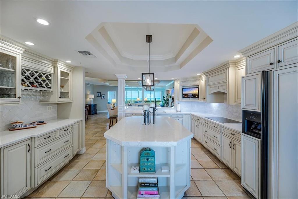 445 Dockside Drive, Unit B902 Naples, FL 34110 - Photo 11 of 29 a kitchen with granite countertop a sink stainless steel appliances and cabinets