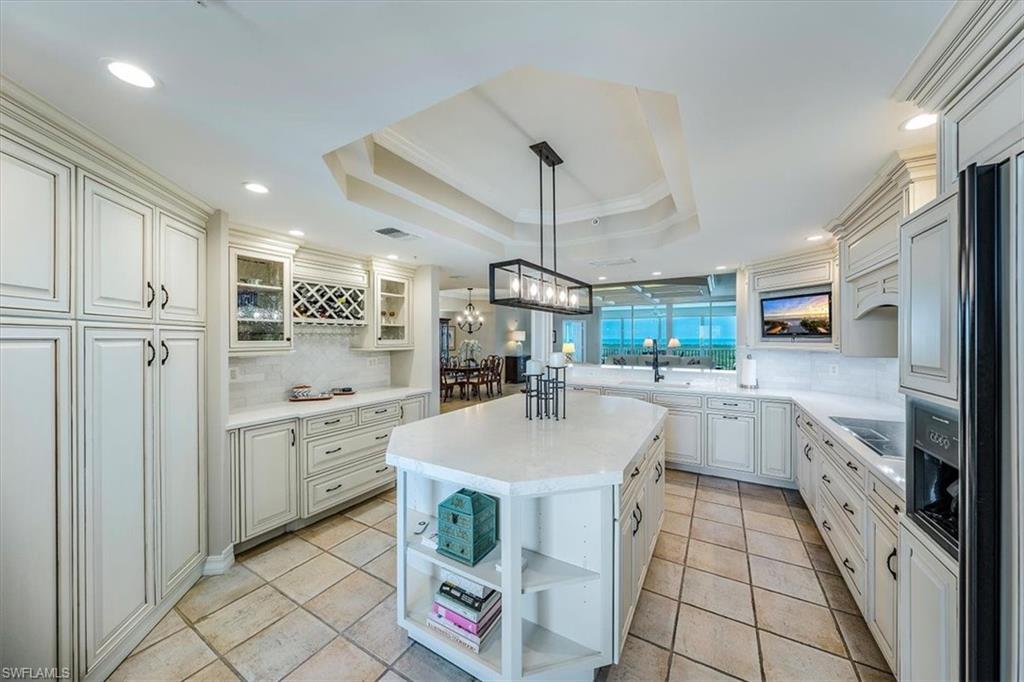 445 Dockside Drive, Unit B902 Naples, FL 34110 - Photo 12 of 29 a kitchen with stainless steel appliances kitchen island granite countertop a sink and cabinets
