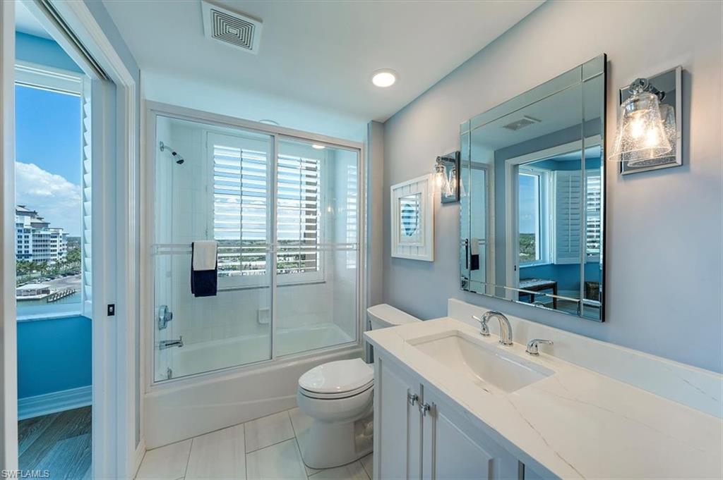 445 Dockside Drive, Unit B902 Naples, FL 34110 - Photo 15 of 29 a bathroom with a sink a toilet and shower