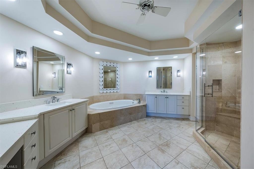 445 Dockside Drive, Unit B902 Naples, FL 34110 - Photo 16 of 29 a large bathroom with a large mirror vanity and shower