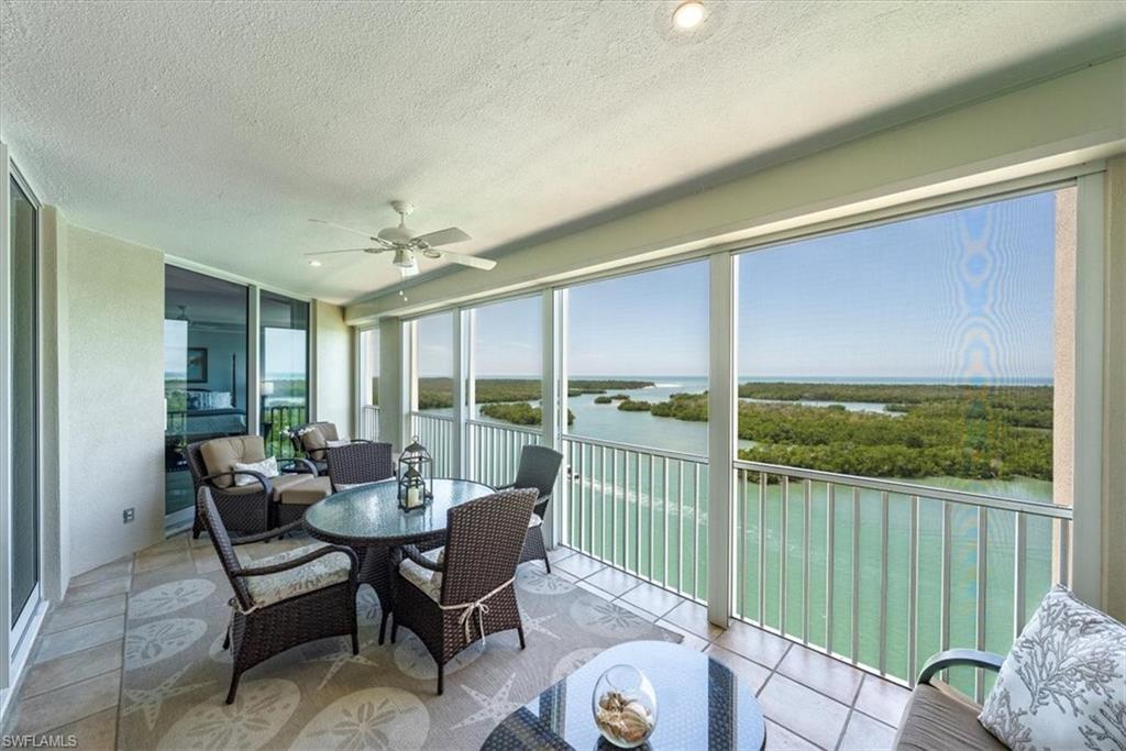 445 Dockside Drive, Unit B902 Naples, FL 34110 - Photo 19 of 29 a living room with furniture and a floor to ceiling window