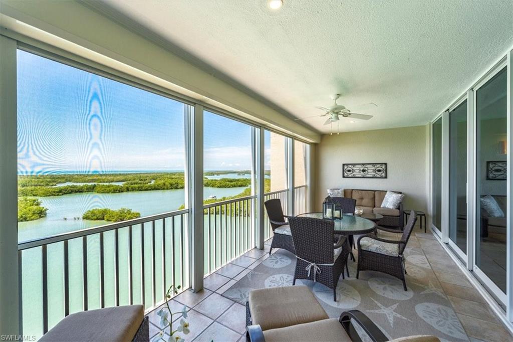 445 Dockside Drive, Unit B902 Naples, FL 34110 - Photo 20 of 29 a living room with furniture and a floor to ceiling window