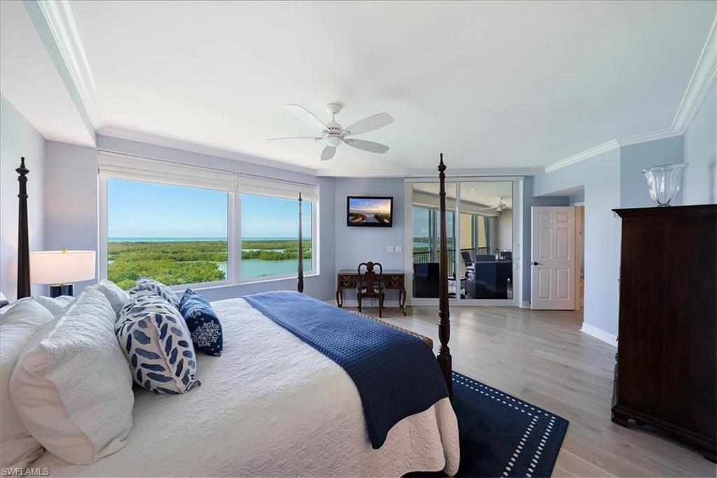 445 Dockside Drive, Unit B902 Naples, FL 34110 - Photo 22 of 29 a bed room with a bed and a television