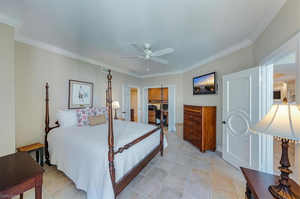 445 Dockside Drive, Unit B902 Naples, FL 34110 - Photo 25 of 29 a bed room with a bed and a flat screen tv