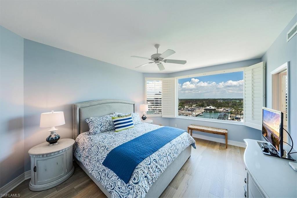 445 Dockside Drive, Unit B902 Naples, FL 34110 - Photo 26 of 29 a bedroom with a bed and a flat screen tv