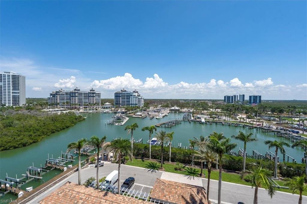 445 Dockside Drive, Unit B902 Naples, FL 34110 - Photo 5 of 29 a view of a lake with a yard