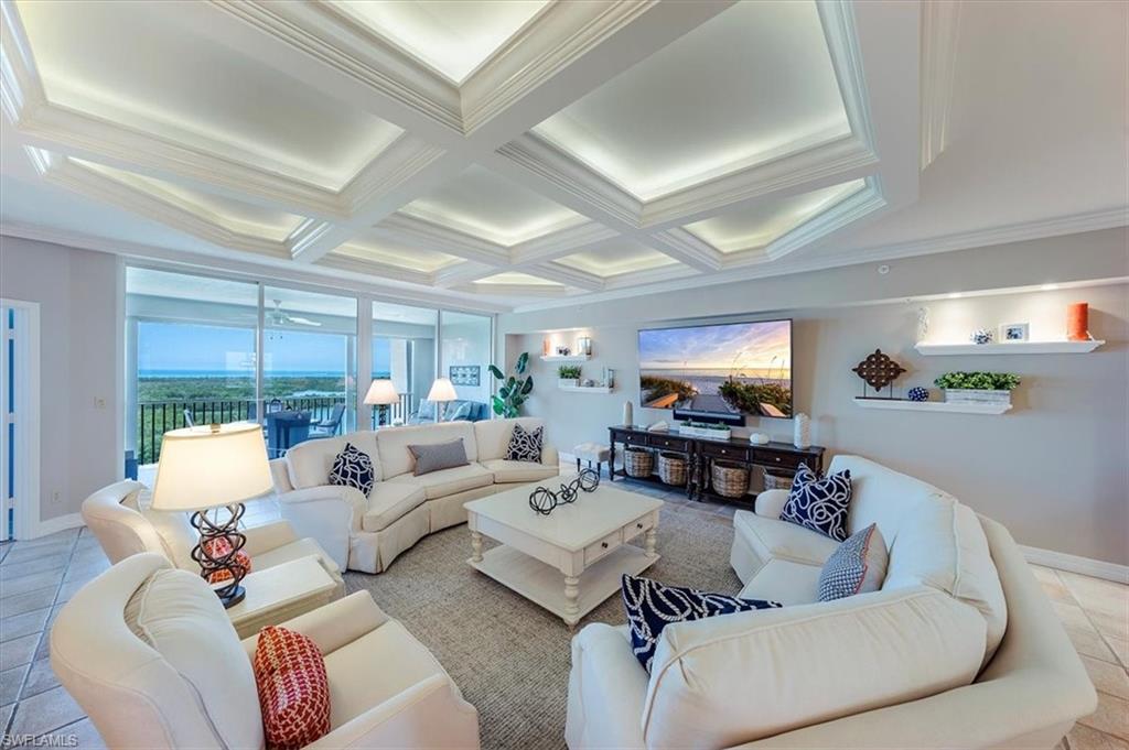 445 Dockside Drive, Unit B902 Naples, FL 34110 - Photo 8 of 29 a living room with furniture and a flat screen tv