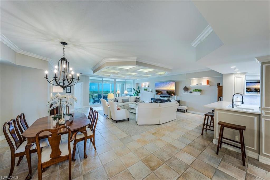 445 Dockside Drive, Unit B902 Naples, FL 34110 - Photo 9 of 29 a living room with fireplace furniture and a chandelier