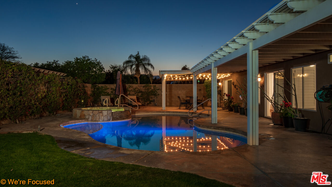 81129 La Reina Circle Indio, CA 92201 - Photo 1 of 46 a view of swimming pool with lawn chairs and plants