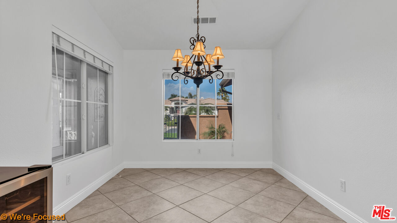 81129 La Reina Circle Indio, CA 92201 - Photo 11 of 46 a view of a room with window and chandelier