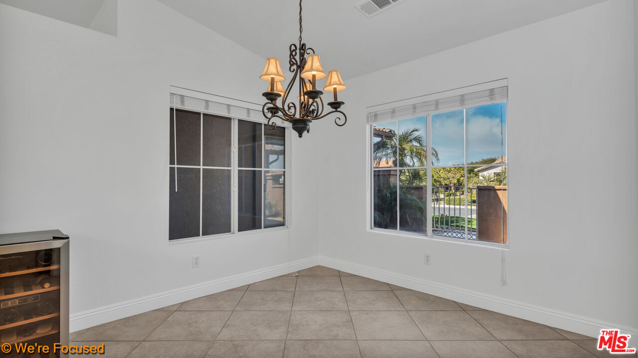 81129 La Reina Circle Indio, CA 92201 - Photo 12 of 46 a view of a room with a chandelier and windows