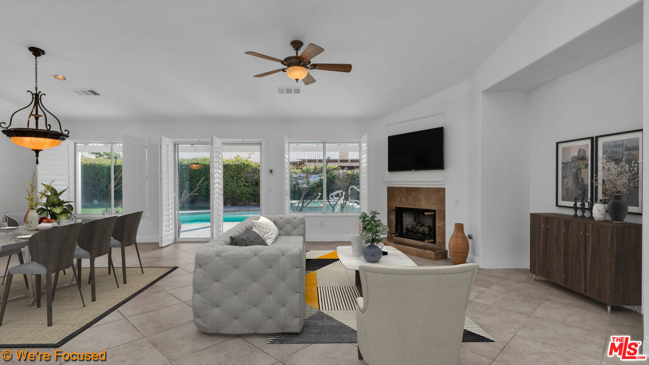 81129 La Reina Circle Indio, CA 92201 - Photo 16 of 46 a living room with furniture a fireplace and a flat screen tv