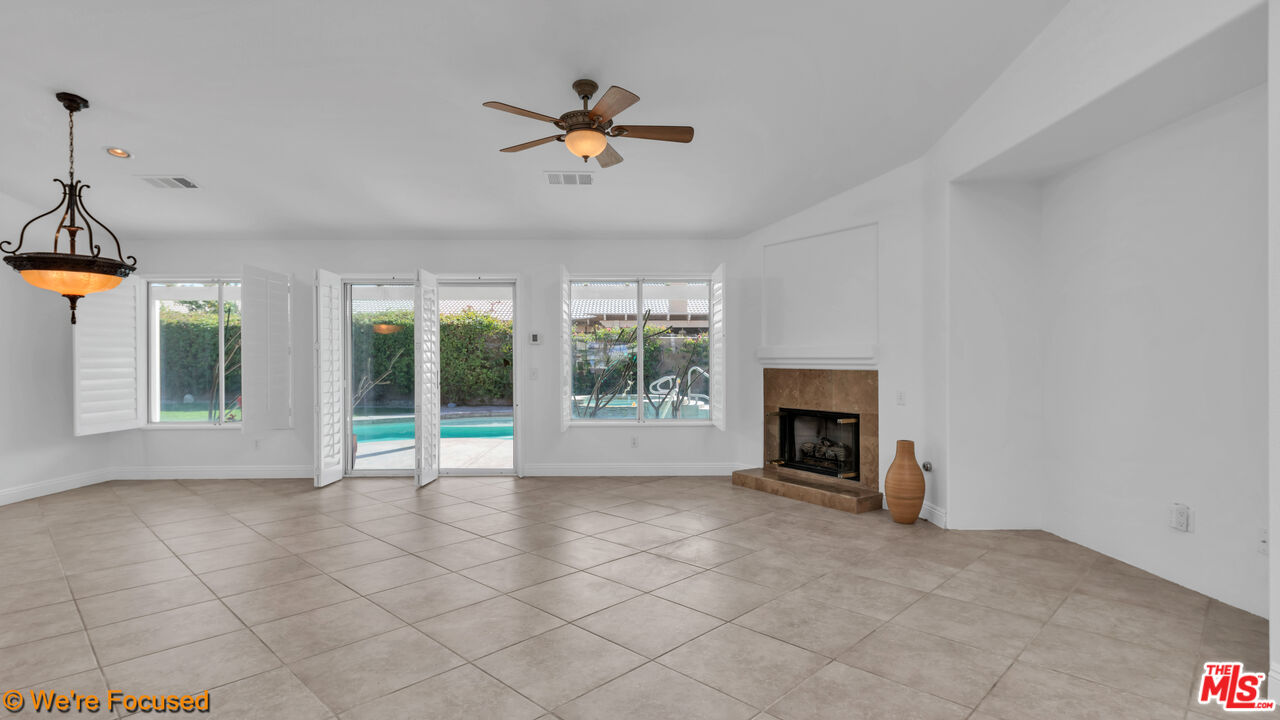 81129 La Reina Circle Indio, CA 92201 - Photo 17 of 46 a view of an empty room with a fireplace and a window