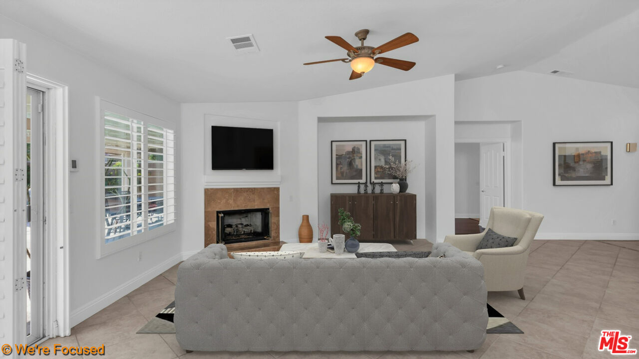 81129 La Reina Circle Indio, CA 92201 - Photo 18 of 46 a living room with furniture and a fireplace