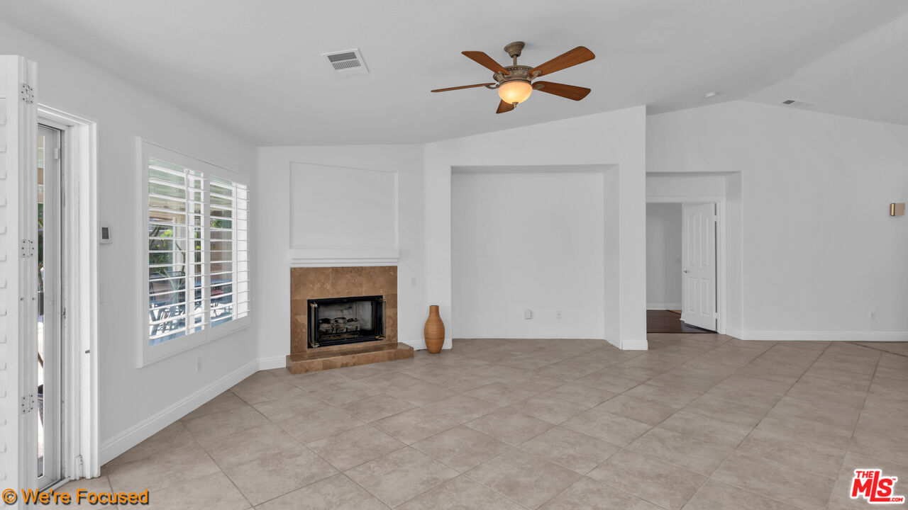81129 La Reina Circle Indio, CA 92201 - Photo 19 of 46 an empty room with windows and fireplace