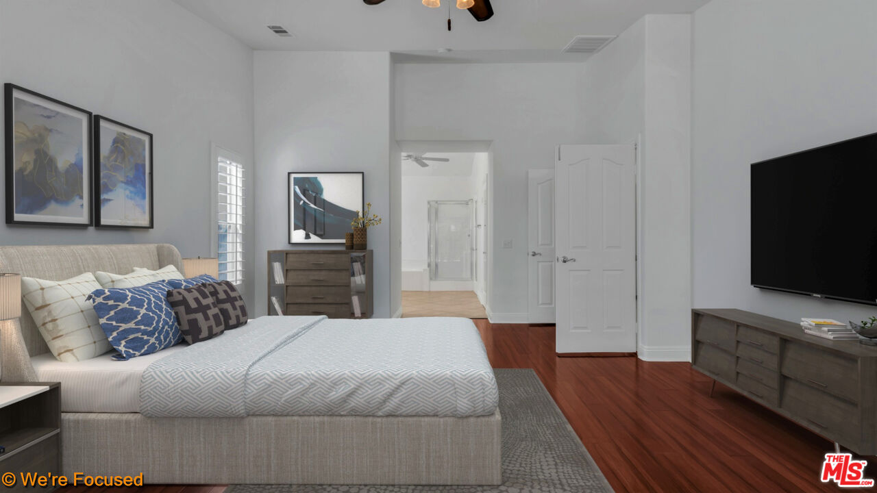 81129 La Reina Circle Indio, CA 92201 - Photo 22 of 46 a bedroom with a bed and a flat screen tv