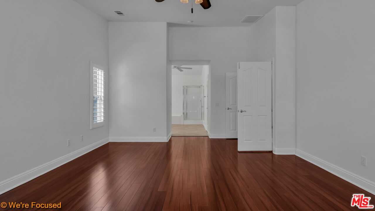 81129 La Reina Circle Indio, CA 92201 - Photo 24 of 46 a view of a room with wooden floor and window