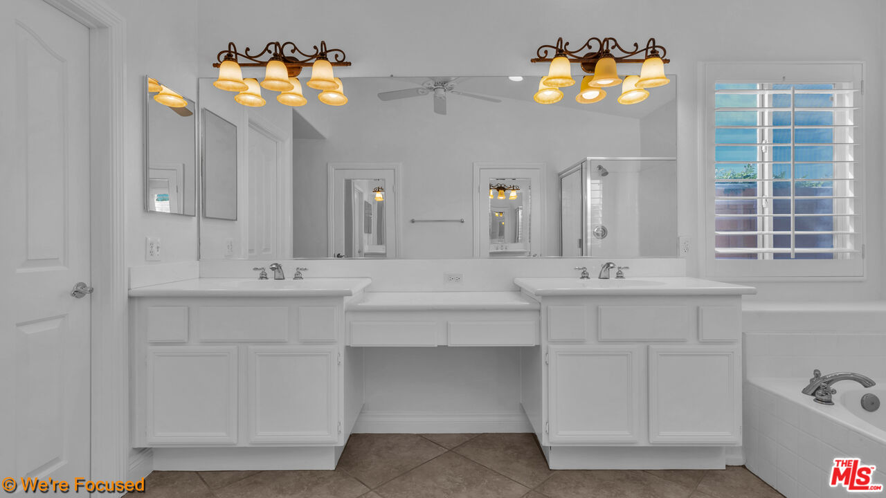 81129 La Reina Circle Indio, CA 92201 - Photo 25 of 46 a bathroom with a sink mirror and vanity