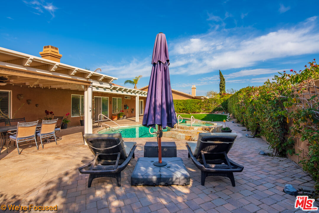 81129 La Reina Circle Indio, CA 92201 - Photo 38 of 46 a building outdoor space with patio furniture and potted plants