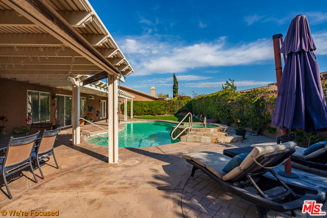 81129 La Reina Circle Indio, CA 92201 - Photo 39 of 46 a view of a patio with table and chairs with wooden floor and fence