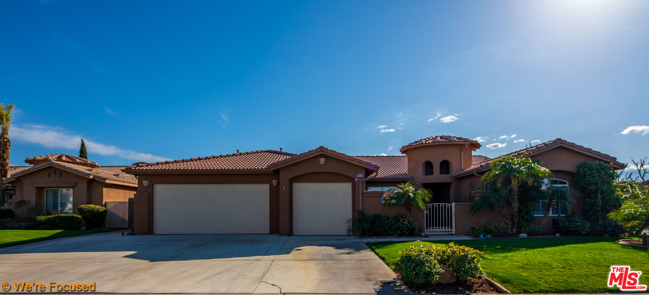 81129 La Reina Circle Indio, CA 92201 - Photo 4 of 46 a front view of a house with a yard and garage