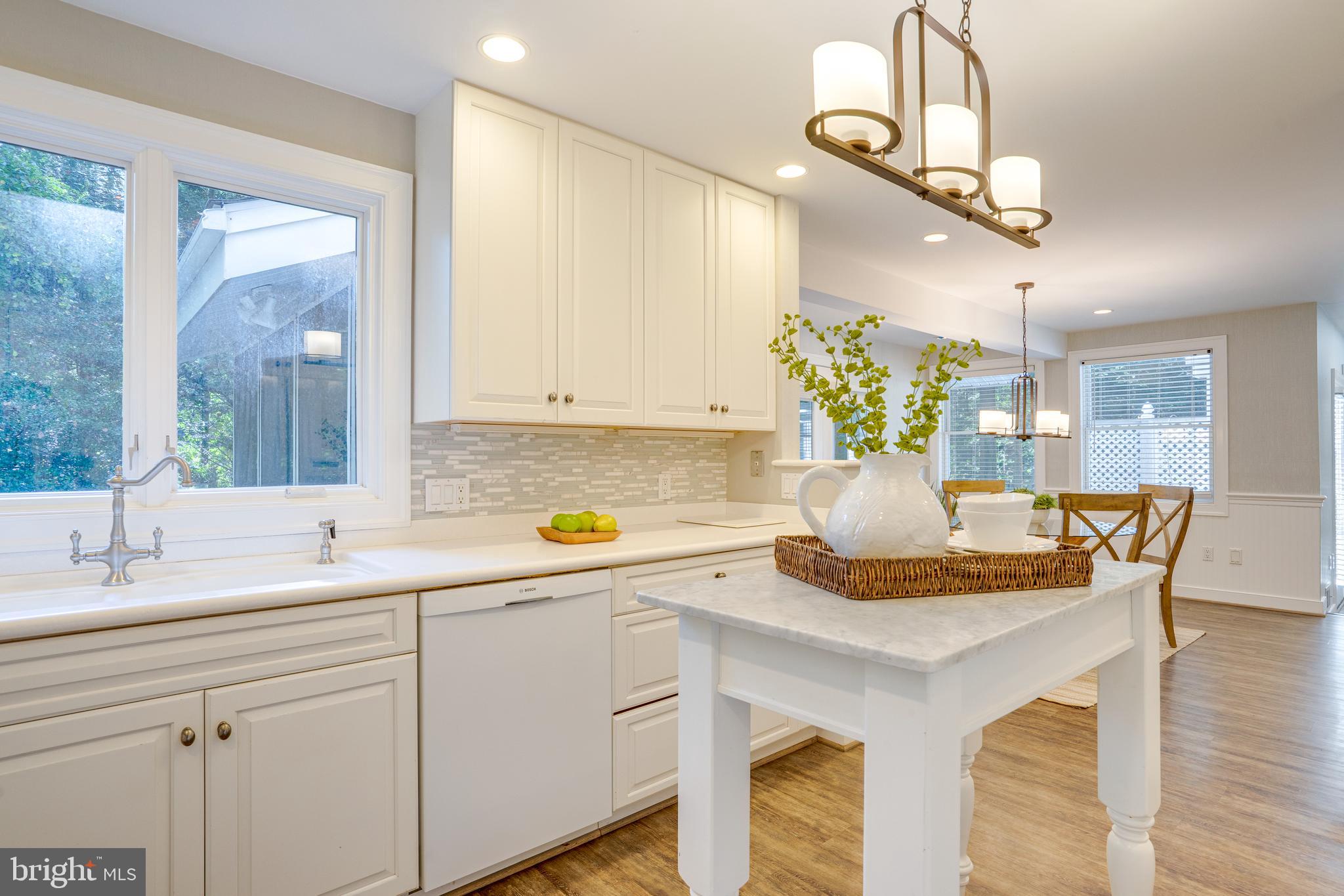 2603 Penny Royal Lane Reston, VA 20191 - Photo 22 of 72 a kitchen with a sink cabinets and dining table
