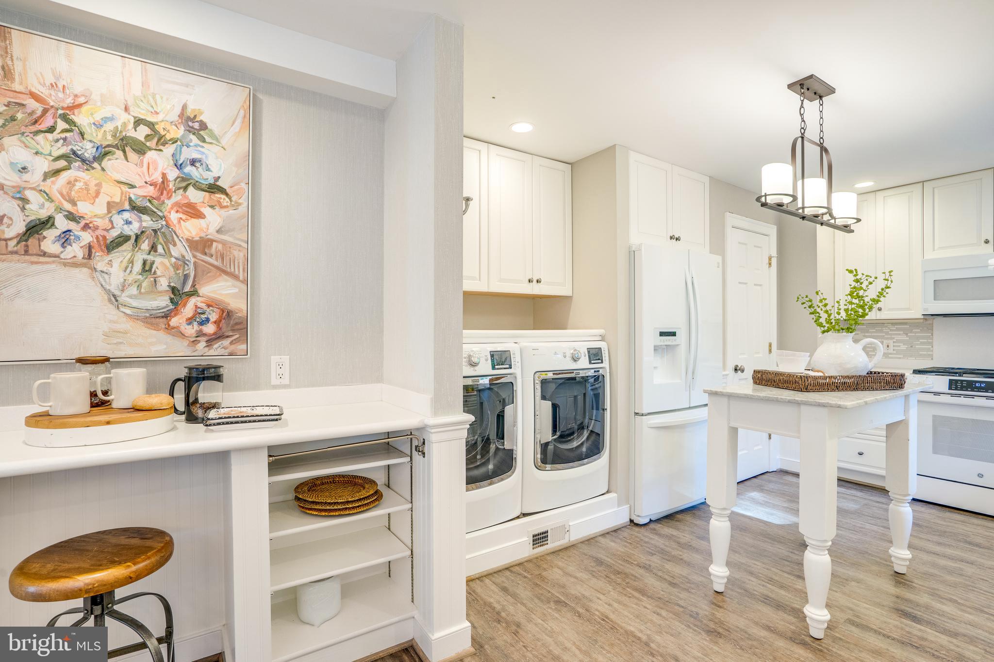 2603 Penny Royal Lane Reston, VA 20191 - Photo 31 of 72 a kitchen with stainless steel appliances granite countertop a stove a sink a microwave a refrigerator and white cabinets with wooden floor