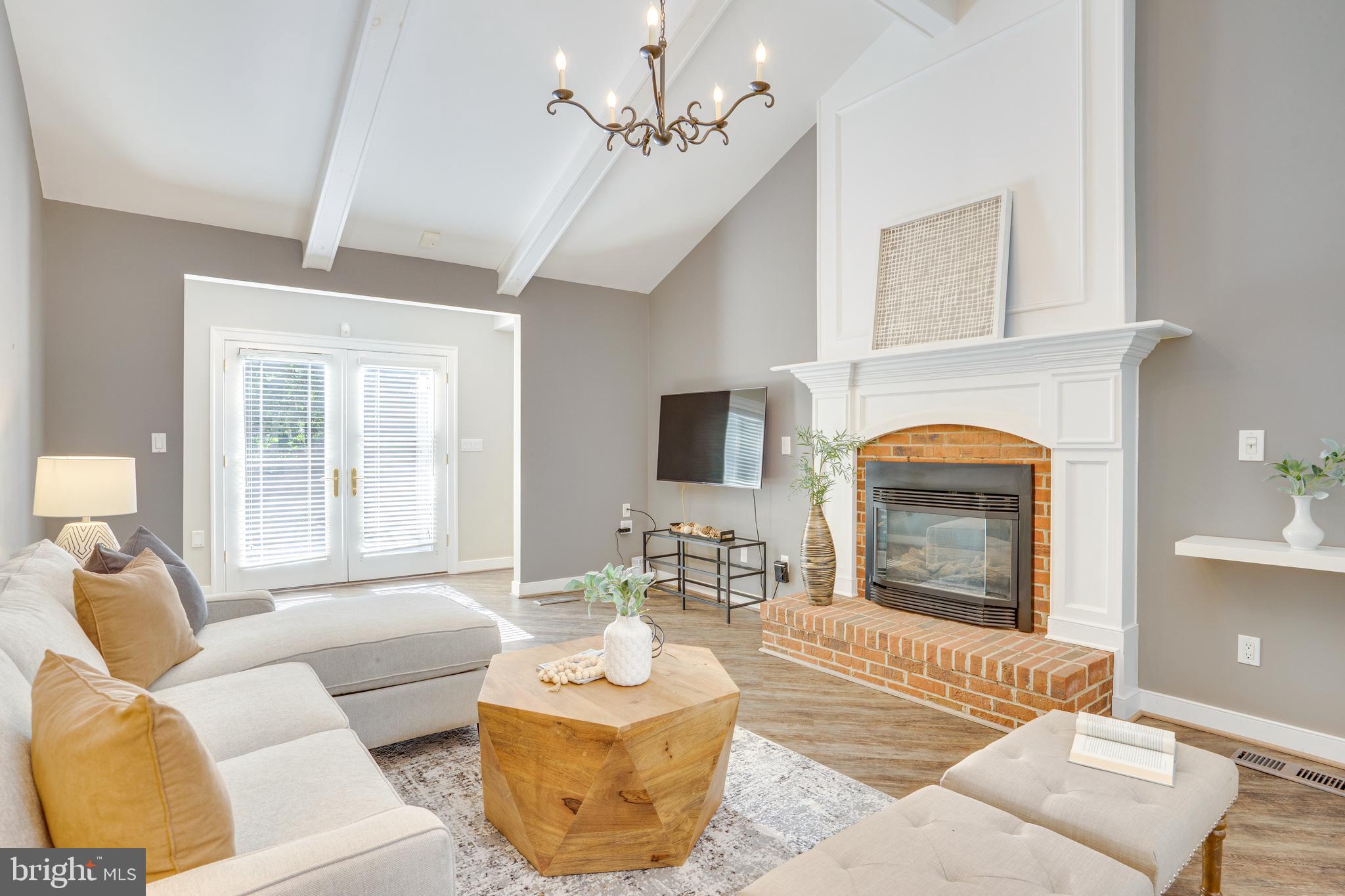 2603 Penny Royal Lane Reston, VA 20191 - Photo 51 of 72 a living room with furniture a fireplace and a flat screen tv