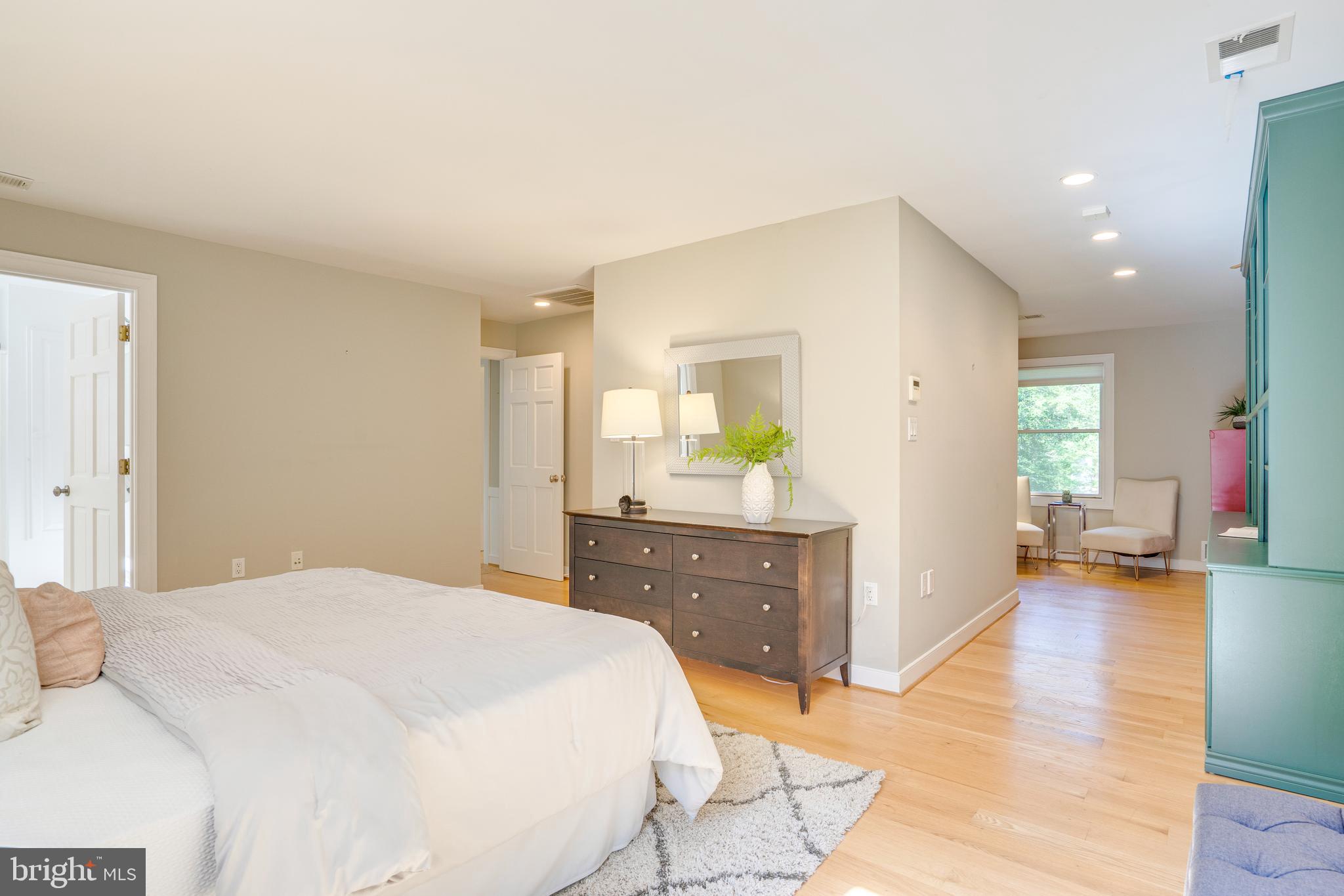 2603 Penny Royal Lane Reston, VA 20191 - Photo 58 of 72 a bedroom with a bed and wooden floor