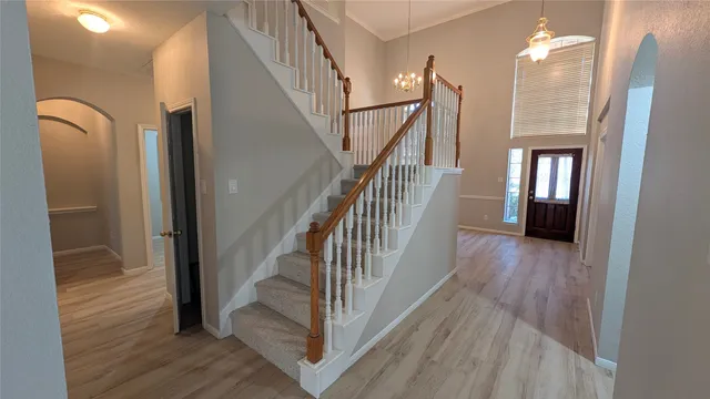 a view of entryway and hall with wooden floor